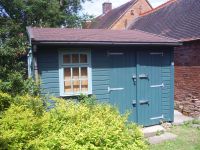 12 x 14 Workroom with Double Doors and a 9 Pane Window. Felt tiles have been added. Customer painted after assembly. 