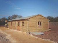 40 x 20 Farm Shop with green felt roof, and garden office doors & windows. 