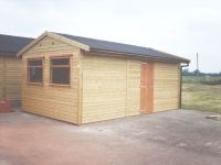 Self Erected Hobby / Workroom with large garage windows and onduline roof. Building made to match farm shop. 