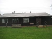 50 x 20 Clubhouse stained in ebony wood protector. Roofing material is metal sheeting onto boarding.