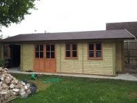 A building for Mallock Sports Cars with a lean to and a covered overhang.