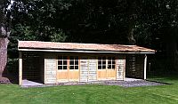 30 x 12 Building with log stores at both ends, with cedar shingles.