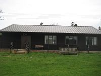 Club House Shiplap Clad finished in Protek Ebony with black metal profile roof