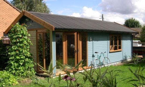 A Warwick Buildings Workroom which has been customer customised. Additions include Black Onduline Roofing, Contemporary Doors and Windows, Protek Wood Protector finish to cladding and a contrasting brown to all joinery
